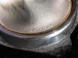 a close up of a metal object on a black surface