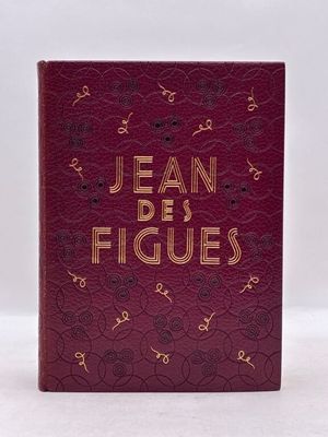 un livre rouge avec des lettres dorées posé sur une surface blanche