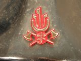a close up of a fire hydrant with a red emblem on it