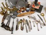 many different types of silverware on the table