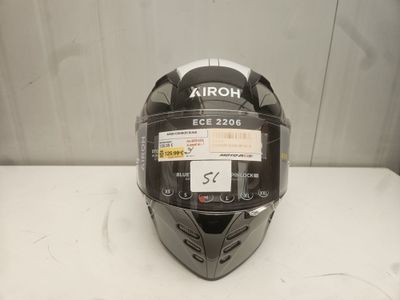 a close up of a helmet on a table with a tag on it