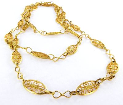 a close up of a gold necklace on a white background