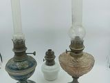 a lot of old lamps that are sitting on a table