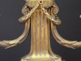 a gold colored candle holder on a wooden table