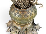 a metal vase with a chain hanging from it