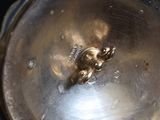 a silver clock that is sitting on top of a table