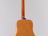 an acoustic guitar hanging from the ceiling
