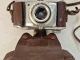 a camera that is sitting on top of a brown bag