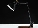 an image of a desk lamp with a wooden base and a black shade