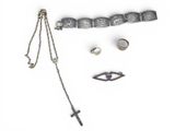 a necklace, bracelet, ring, and other jewelry on a white surface
