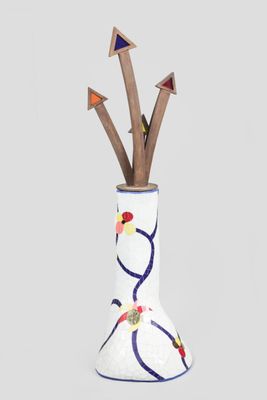 a vase that has arrows sticking out of it