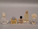 three small bottles of perfume sitting next to each other on a table
