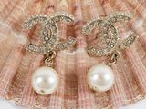 chanel pearl and diamond earrings on a seashell