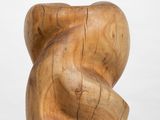 an image of a wooden sculpture on a pedestal on a white surface