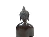 statue of a seated buddha on a pedestal on a white background
