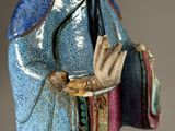 statue of a woman in a blue dress with a blue hat and a blue robe