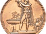 an image of a bronze medal depicting a man holding a baby