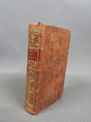 an old book sitting on top of a table next to a gray background