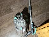 a vacuum that is sitting on the floor next to a dresser