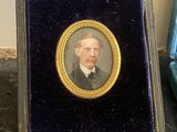 a miniature picture of a man in a suit and tie
