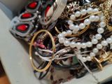 a white box filled with lots of different types of jewelry