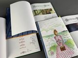 an open book with a picture of a woman in a dress on it