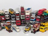 a lot of toy buses that are sitting on a table