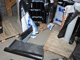 a pile of black plastic items on a pallet
