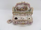 a small porcelain box with a painting on it