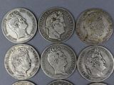 six different types of silver coins are shown on a blue surface