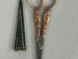 a pair of scissors sitting next to a pair of scissors