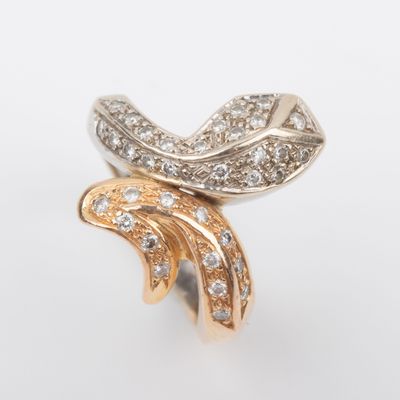 a close up of a gold and diamond ring on a white background
