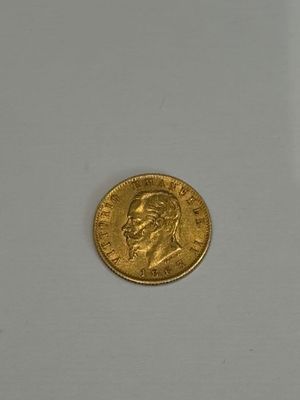 a close up of a gold coin on a white surface