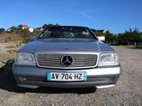 a silver car that is parked in the dirt