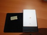 a tablet computer sitting on a desk with a notepad