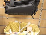 a black bag hanging on a wall next to a laptop