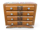 a wooden chest of drawers with a marble top