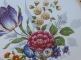 a plate with a floral design on it on a table
