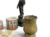 a group of asian vases and bowls on a white surface