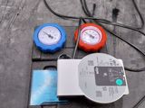 two gauges on the back of a car with wires