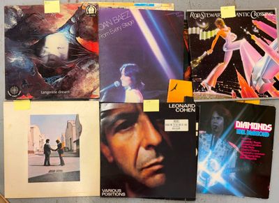 a lot of vinyl records that are on the table