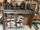 many chairs that are stacked on a shelf in a room