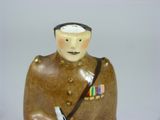 a figurine of a man in a military uniform