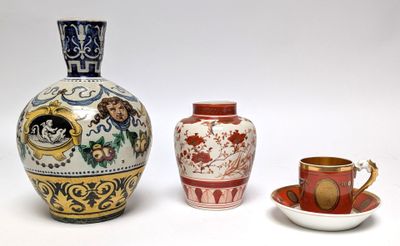 three vases and a cup sitting next to each other