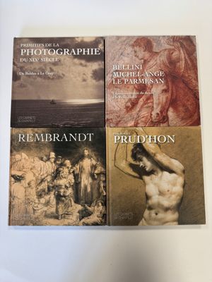 trois livres posés sur une table blanche, dont l'un se trouve face à la caméra