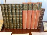 several old books are lined up on a wooden table