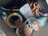 a cardboard box filled with assorted items and tape
