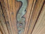 a close up of a door handle on a wooden door
