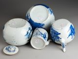 a group of blue and white tea cups and saucers