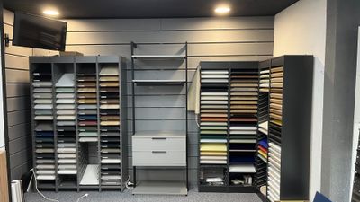 a large room with a lot of shelves and a tv